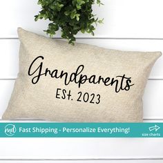 a pillow that says grandparents est 2093 on it next to a potted plant