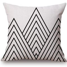 a black and white pillow with an abstract design on the front, which is made out of