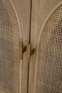 a close up of a wooden door with wickers on the outside and inside