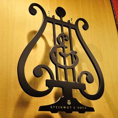 a metal sign on the side of a wooden wall that says steinway & sons