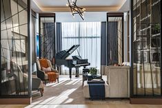 a living room filled with furniture and a grand piano in the middle of it's walls