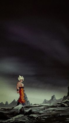 a man standing on top of a snow covered slope under a dark sky with mountains in the background