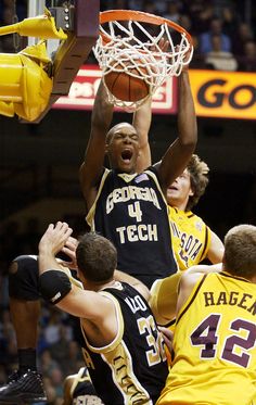 a group of young men playing a game of basketball