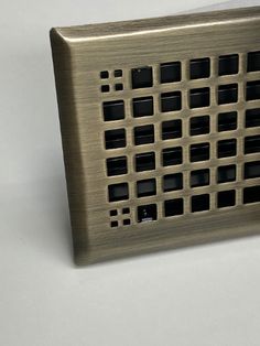 a metal object with squares and holes on it