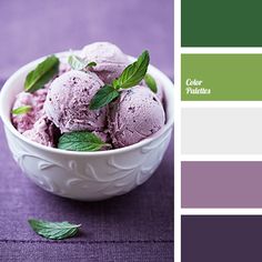 a white bowl filled with ice cream next to a purple and green color swatch