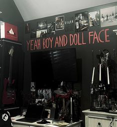 a room filled with lots of musical equipment and pictures on the wall above it that says yeah boy and doll face