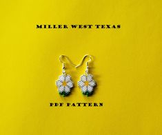 a pair of white and green beaded earrings on a yellow background with the words miller west texas