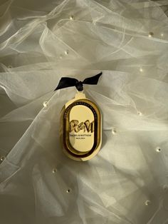 an ornament with the initials v and w on it sitting on a wedding dress