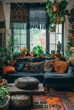 a living room filled with lots of potted plants next to a couch and window