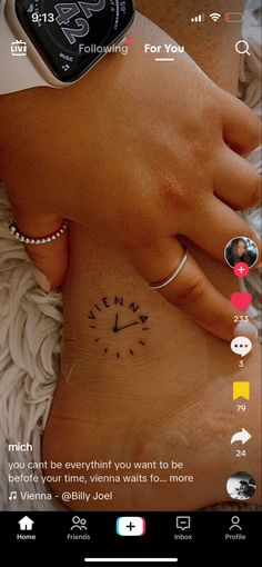 a person with a wrist tattoo on their left hand and an apple watch in the background