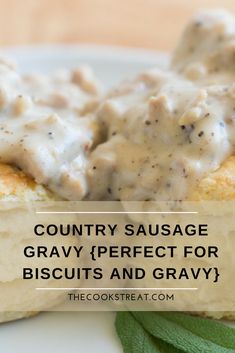 two biscuits covered in gravy on top of a white plate