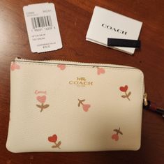 Adorable Coach Heaets And Fkowers Print Corner Zip Wristlet On Chalk Background With Burgundy Wrist Strap. Brand New, Never Used And Rare. Looks Gorgeous With The Red Coach Purse For Sale In My Closet. 6 1/4" X 4". Gold Tone Coach Emblem And Hardware. Smoke Free Home. No Returns Please. White Wallets For Spring Gift, Coach Wallets As Spring Gifts, Cream Pouch Wristlet Gift, Cream Pouch Wristlet For Gift, Cream Pouch Wristlet As Gift, Chalk Background, Hearts And Flowers, Black Wristlet, Leather Card Case