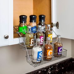 an organized spice rack in the corner of a kitchen cabinet with spices and seasonings