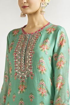 Mint tunic with all-over floral prints, embroidered yoke, sleeves and borders. - Aza Fashions Green Floral Embroidered Straight Kurta, Green Floral Embroidery Tunic, Green Straight Kurta Sets With Embroidered Neckline, Green Floral Print Tunic Kurta, Anarkali Tunic With Floral Embroidery, Traditional Green Kurta With Embroidered Neckline, Traditional Floral Print Tops For Eid, Festive Straight Kurta Blouse With Floral Print, Traditional Green Tunic With Floral Embroidery