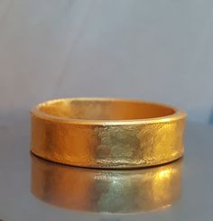 24k Solid Yellow Gold Hammered Band Custom-made  There is nothing like 24k Gold. Hand fabricated using ancient goldsmithing methods from pure 24 karat gold,  the same form this precious metal is found in nature. The difference in purity over man-made chemical alloys of 14-18 karats (58%-75%) is instantly observed and felt. It  will never tarnish, is hypoallergenic, and antimicrobial. There is a myth that jewelry cannot be crafted from pure 24 karat gold due to its softness. While it is true that Mens Gold Rings, Hammered Band, Gold Hand, Wedding Band Ring, 14k Gold Ring, Gold Wedding Band, Precious Metal, Pure Gold, Mens Wedding Bands