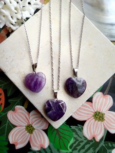 This polished genuine amethyst heart pendant hangs from your choice of chain.The February birthstone, amethyst, is said to strengthen relationships and give its wearer courage. At one time, only royalty could wear the gem. Ancient Greeks thought that the amethyst guarded against intoxication. In fact, “amethyst” comes from amethystos, a Greek word meaning “sober.”Amethysts are the birthstone for February and also traditionally given on the 6th wedding anniversary.- 18" Rhodium Plated Chain. ‚Ä¢ Purple Amethyst Heart Necklaces, Purple Amethyst Heart Necklace, Purple Heart-shaped Amethyst Necklaces, Crystal Heart Pendant Necklace With Heart Charm, Purple Heart Amethyst Necklace, Amethyst Birthstone Crystal Necklace Gift, Amethyst Pendant Crystal Necklace Gift, Amethyst Heart Pendant Jewelry For Anniversary, Spiritual Heart-shaped Nickel-free Necklace