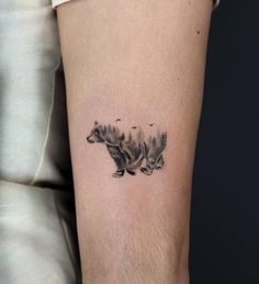 a small bear tattoo on the leg