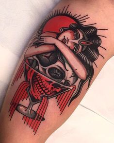 a tattoo with a woman holding a skull on her arm