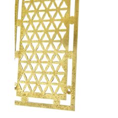 a gold metal object with geometric designs on the front and back side, against a white background