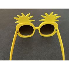 a pair of yellow sunglasses with pineapples on them