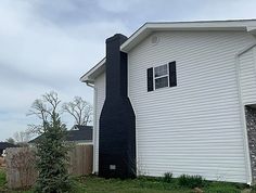 a black and white fire hydrant in front of a house