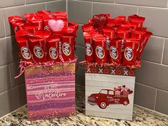 valentine's day candy bouquet in a gift bag next to a box of chocolates