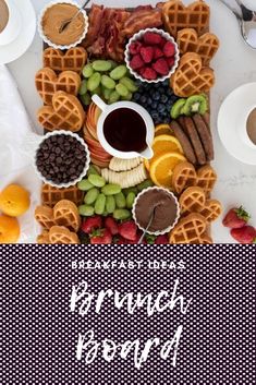 a table topped with waffles, fruit and chocolate