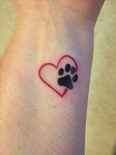 a small paw print on the wrist with a heart shaped dog's paw in it