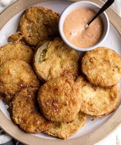 some fried food on a plate with dipping sauce