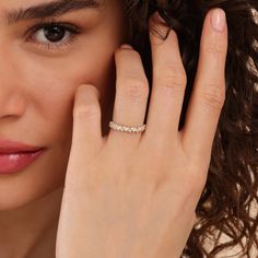 a close up of a person wearing a ring with a diamond on the middle finger