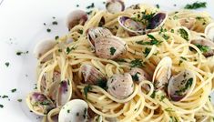 pasta with clams and parsley on white plate