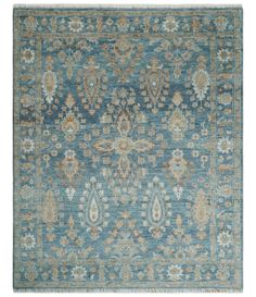 a blue rug with an ornate design on the top and bottom, in various colors