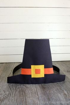 a paper witch hat sitting on top of a wooden floor