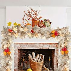 a fireplace decorated with fall leaves and flowers