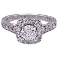 a diamond ring with two rows of diamonds on the band and a center stone surrounded by smaller round stones