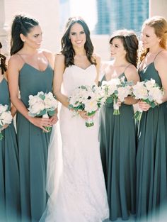 the bride and her bridesmaids are all dressed in different shades of green dresses