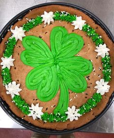 a cake decorated with green frosting and white flowers