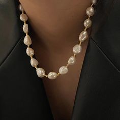 The necklace consists of irregularly shaped freshwater pearls and small golden beads. The pearl particles are white and shiny, and each pearl is separated by small gold beads, adding a noble and elegant temperament. This design not only retains the natural beauty of pearls, but also adds a modern sense of fashion. The natural form of the pearl makes each one have its unique beauty, suitable for matching a variety of different styles of clothing, both daily wear, can also show elegance and taste Pearl White Necklace With Pearl Drop, Baroque Pearl Chain Necklace In Pearl White, Pearl White Baroque Pearl Necklace With Pearl Chain, Pearl White Necklace With Baroque Pearl Chain, Gold Baroque Pearl Beaded Necklace, Gold Beaded Baroque Pearl Necklace, Pearl White Beaded Necklace With Baroque Pearls, Pearl White Beaded Necklaces With Baroque Pearls, Beaded Baroque Pearl Necklace In Pearl White