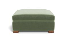 a green ottoman with wooden legs on a white background