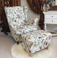 a chair and ottoman in a room with curtains