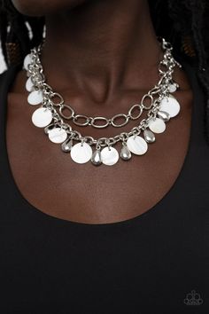 A pair of mismatched chunky silver chains layer below the collar. Shiny silver teardrop beads and white shell-like discs dance from the bottom of the lowermost chain, creating a tropical inspired fringe. Features an adjustable clasp closure.

Sold as one individual necklace. Includes one pair of matching earrings. Bling Necklace, Silver Chains, Teardrop Beads, Paparazzi Accessories, White Necklace, Paparazzi Jewelry, Short Necklace, Stylish Jewelry, Shiny Silver