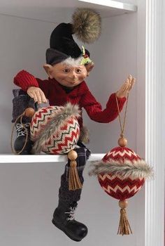 a elf doll sitting on top of a shelf