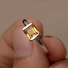 square citrine ring, citrine wedding ring, yellow citrine ring, natural citrine ring, dainty citrine ring, carnelian rings ★ To change the metal to a 10k/ 14k/ 18k solid gold (white/rose/Yellow) is also available, please ask for a quotation if you want. Stone Details : Variety - Natural Square Cut Yellow Citrine Weight: 1.24 CT 1 gem Size: 6 x 6 mm Shape: Square Metal Stamp: 925K/10K/14K The basic metal is sterling silver and plated with rhodium. To change the metal to a solid gold (white/rose/Y Yellow Citrine Birthstone Ring, Yellow Square Cut Rings For Gift, Gift Diamond Cut Citrine Ring, Yellow Citrine Engagement Silvet Ring, Citrine Ring With Rectangular Stone For Gift, Silver Citrine Ring With Diamond Cut, Yellow Citrine Topaz Ring Rectangular Shape, Yellow Citrine Rectangular Rings, Square Cut Ring