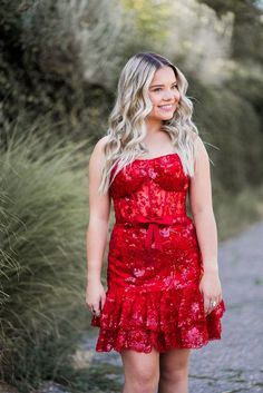 A model in a Sherri Hill strapless sequin cocktail dress showcases a sheer corset bodice, satin bow belt and ruffle hem. Strapless Corset For Prom Season Party, Red Ruffled Corset For Party, Strapless Sequined Corset For Prom, Sequin Corset Dress For Prom And Homecoming, Sequin Corset Dress For Homecoming And Prom, Sequined Corset Dress For Homecoming And Prom Season, Glamorous Strapless Corset Dress For Homecoming, Strapless Sequin Corset Dress For Prom, Strapless Sequined Corset Dress For Prom Season