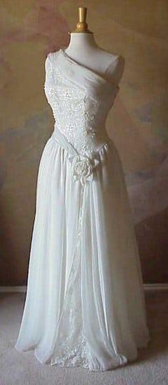 a white wedding dress on a mannequin