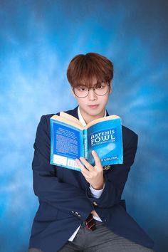 a person sitting down and reading a book