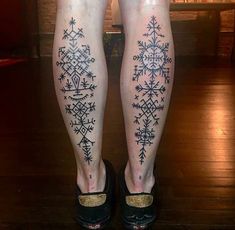 the legs are decorated with snowflakes and stars in black ink on a woman's leg