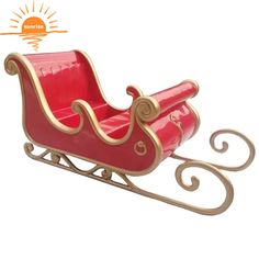 a red toy sleigh sitting on top of a white floor next to a sun