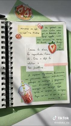 an open notebook with writing on it next to a cup of coffee and strawberries