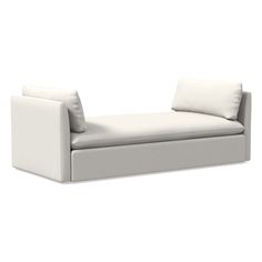 a white couch sitting on top of a white floor